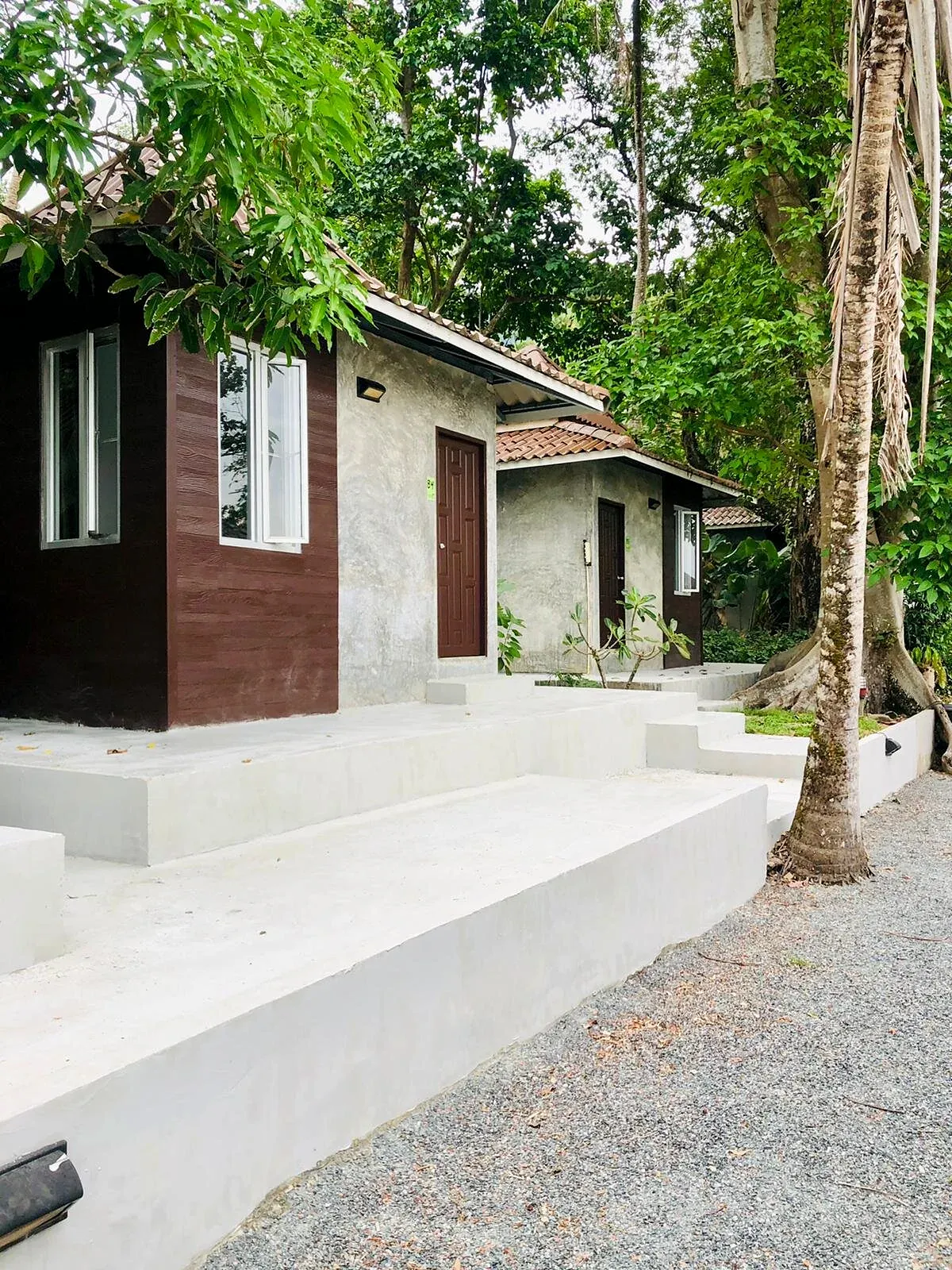 Garden Bungalow with a white terrace under palm trees