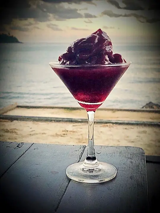 Purple frozen cocktail by the sea