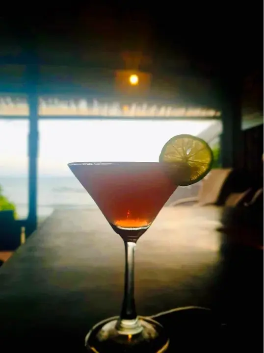 Cocktail on the deck with the sea at dusk