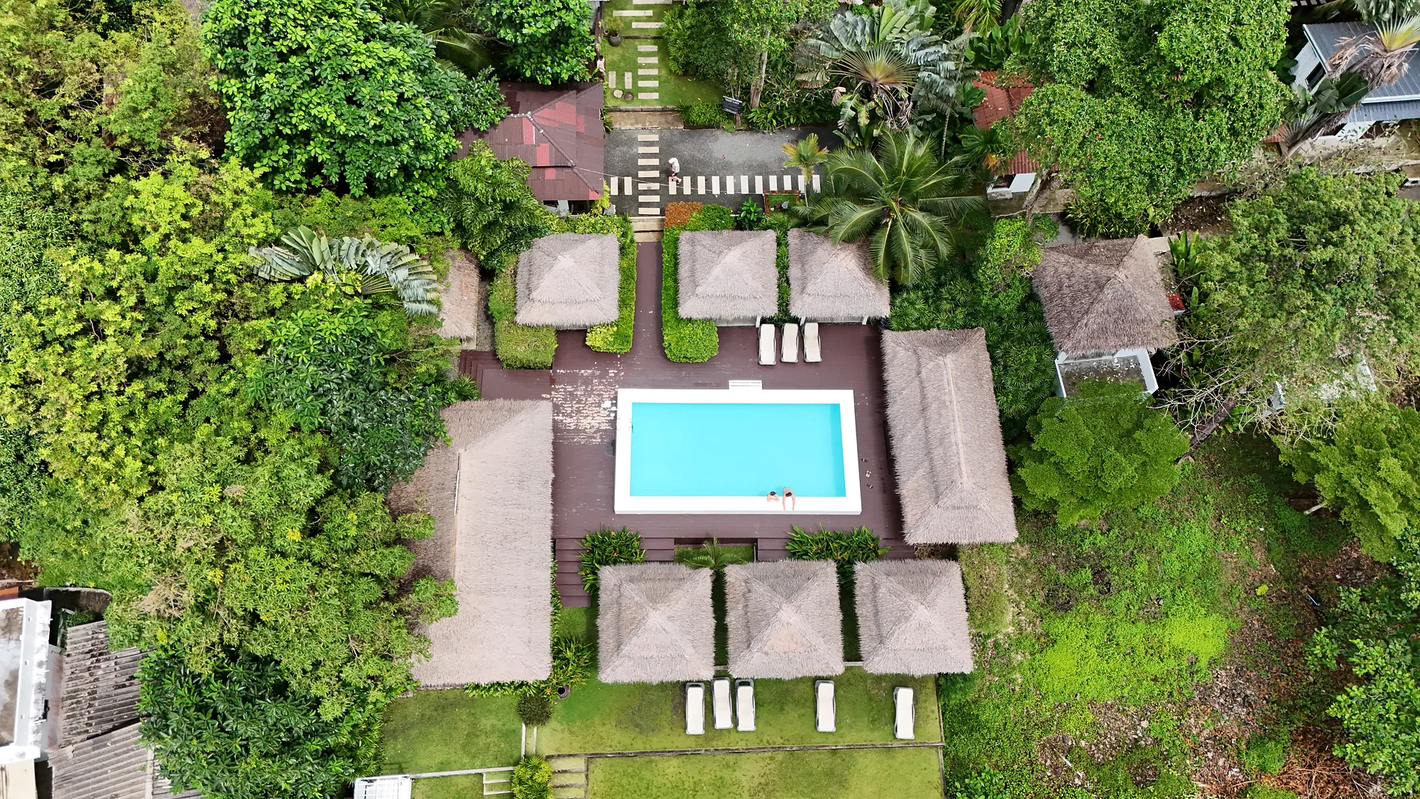 Top-down drone view of the pool, the salas and the garden