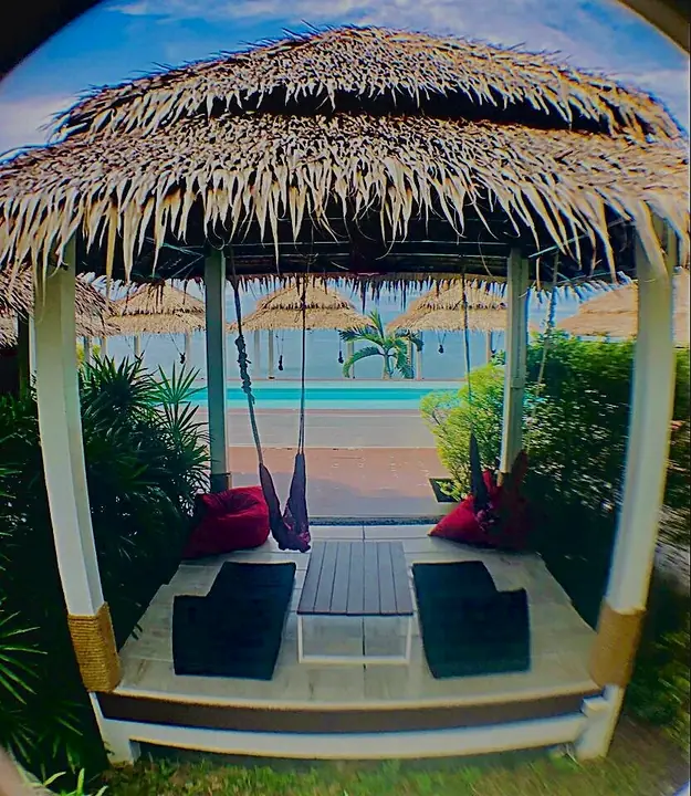 Cabana with cushions facing the pool