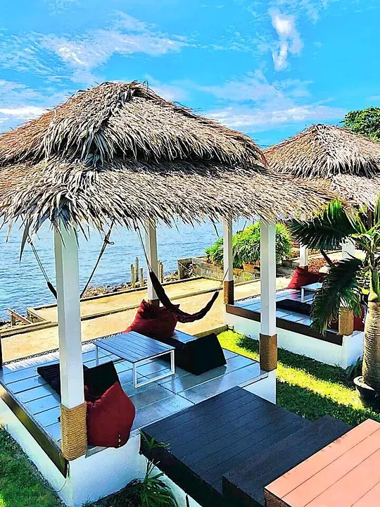 Cabana with a hammock and a sea view under a blue sky